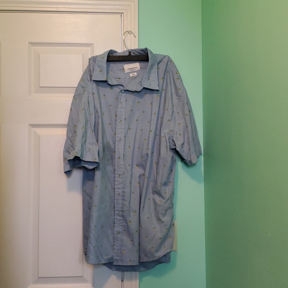 Light blue short sleeved button shirt w/ pineapple